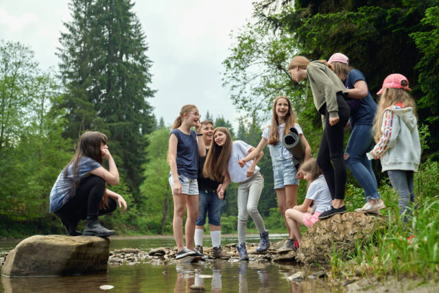 Teenage friends having fun on river